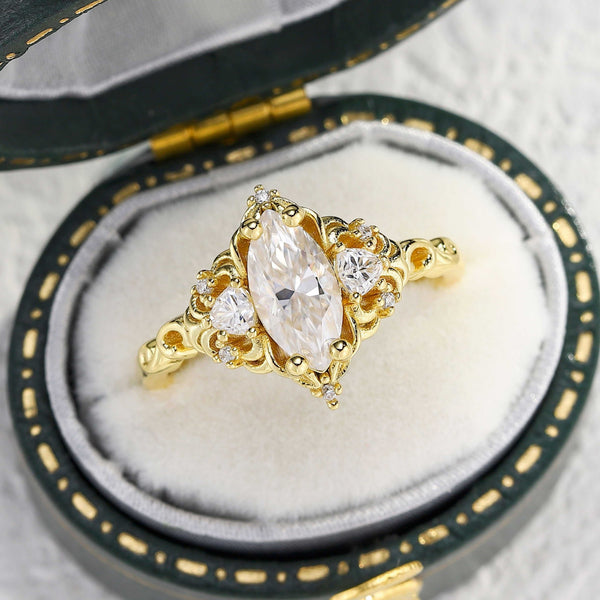Feloriel three-stone gold engagement ring with marquise moissanite center stone and side diamonds in vintage box