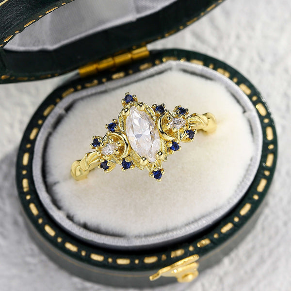 Veloriel three-stone engagement ring with 0.7 carat marquise-cut moissanite and gold setting in a jewelry box