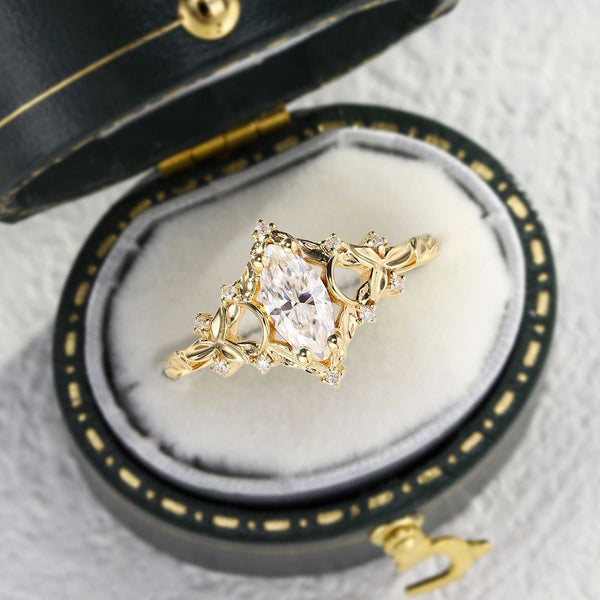 Wilaria solitaire engagement ring with marquise moissanite centerpiece in gold setting
