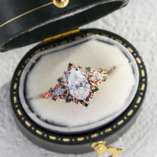 Belinor ring with pear-shaped moissanite center stone and delicate side stones in a vintage ring box