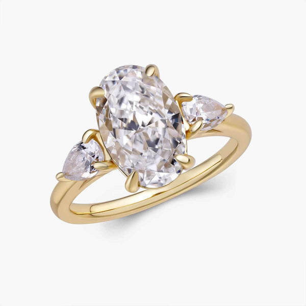 Heloriel engagement ring with oval moissanite center and pear-shaped side stones in gold band