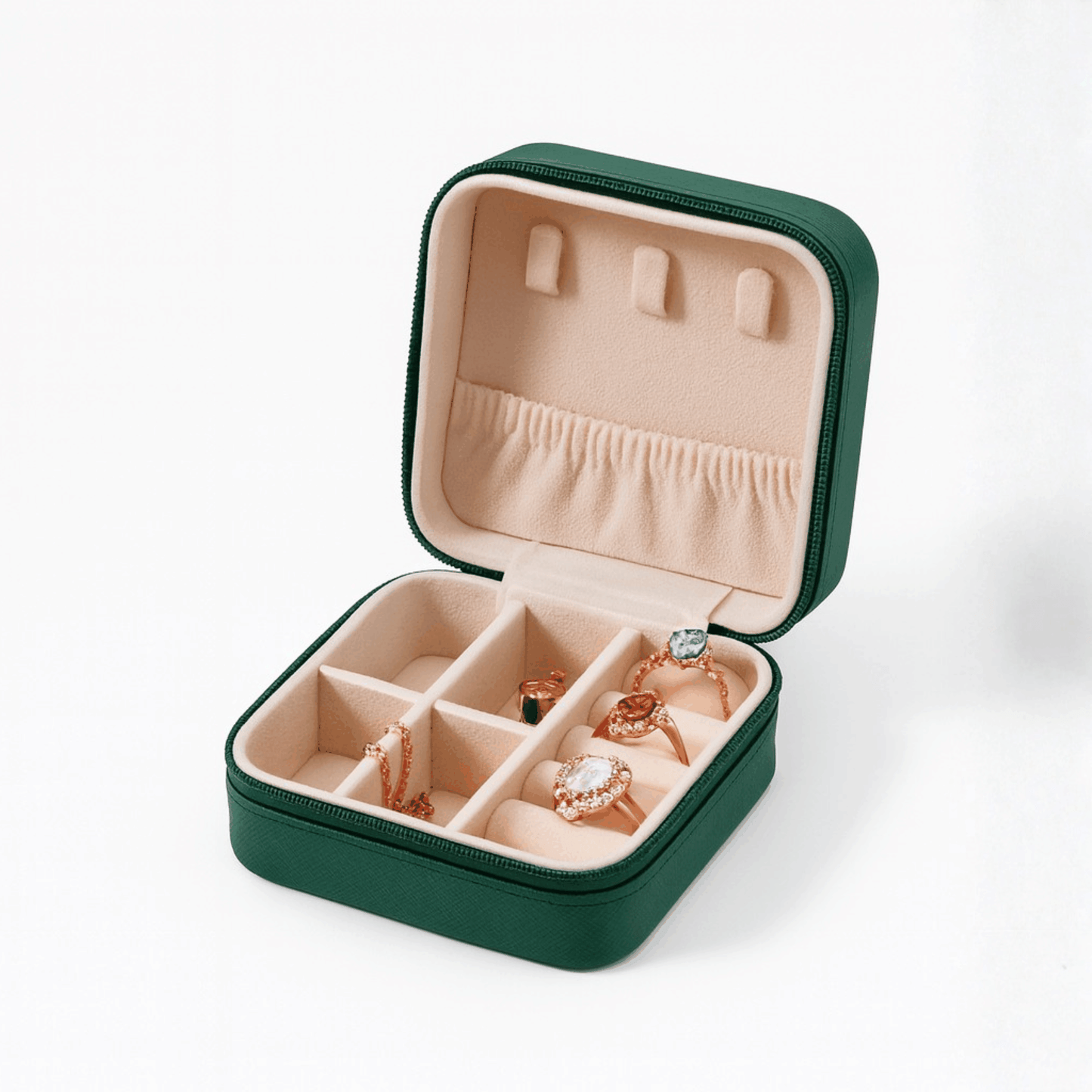 Green leather travel case with beige interior, compartments for jewelry storage