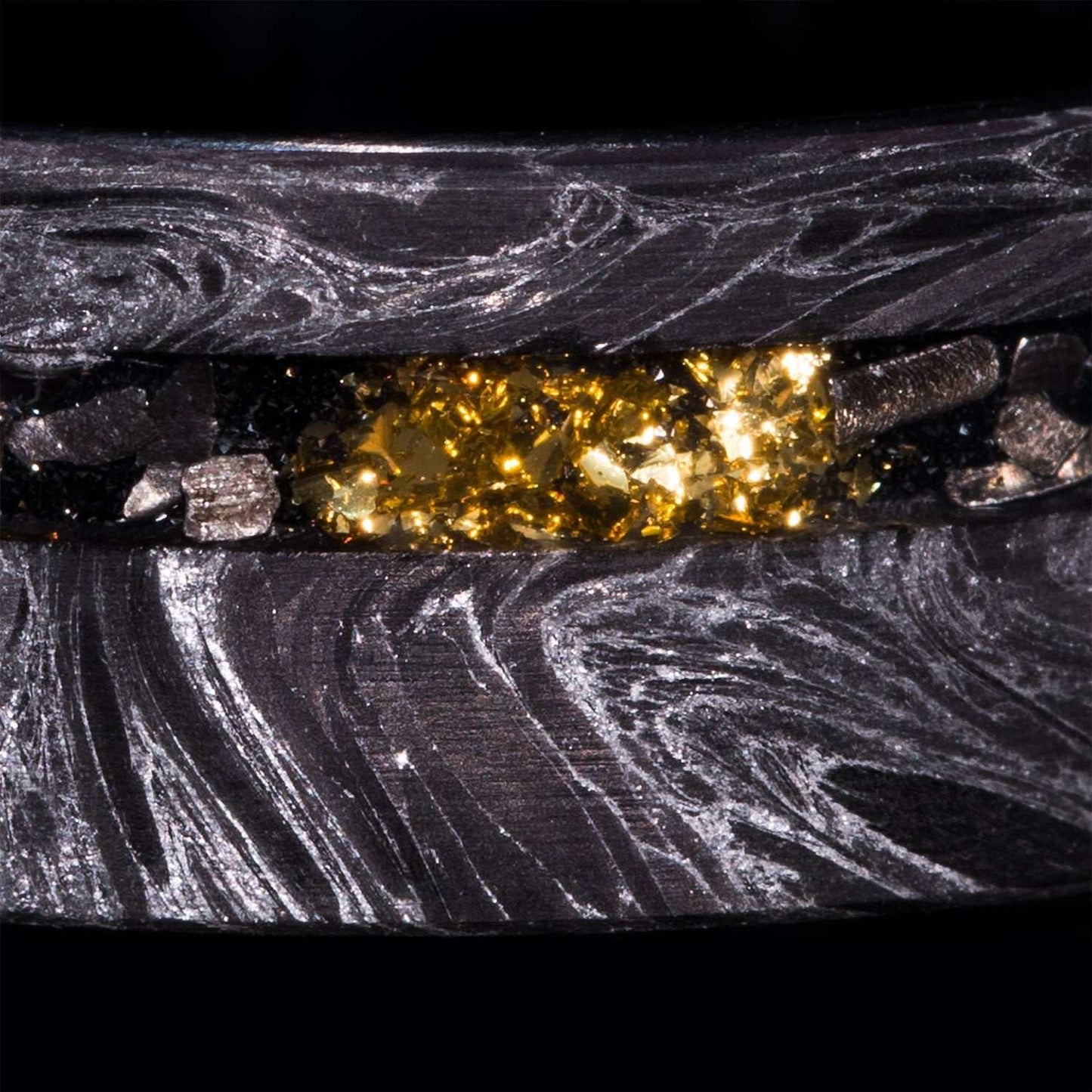 Close-up of 8mm eternity wedding ring with silver swirl carbon fiber, Gibeon Meteorite, and 22k gold foil inlay