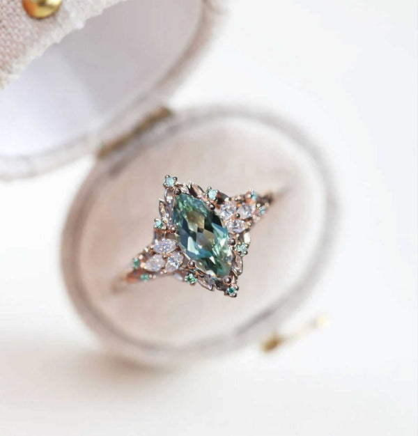 Wendelith solitaire engagement ring with marquise sapphire and moissanite side stones on delicate band