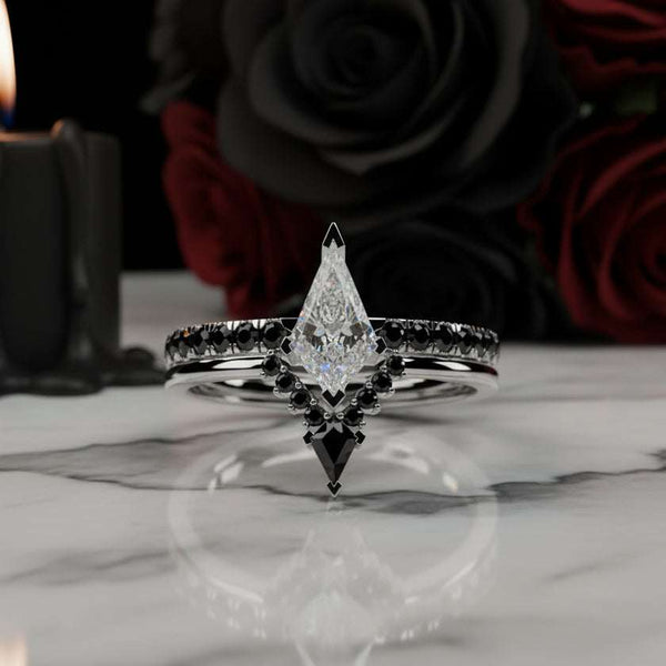 Voraviel stackable ring with 1.5ctw kite-shaped moissanite and black gemstone accents on marble surface