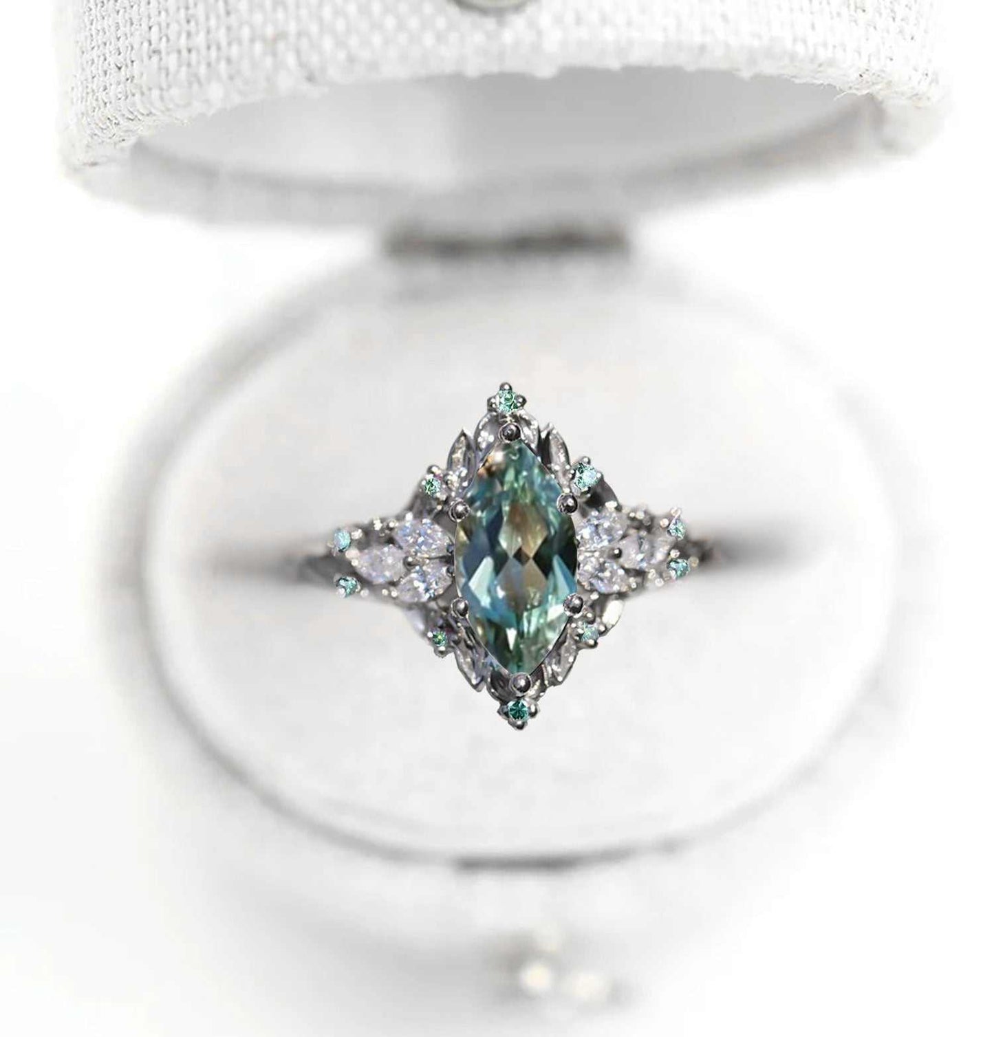 Wendelith solitaire engagement ring with marquise sapphire and moissanite side stones in delicate band design