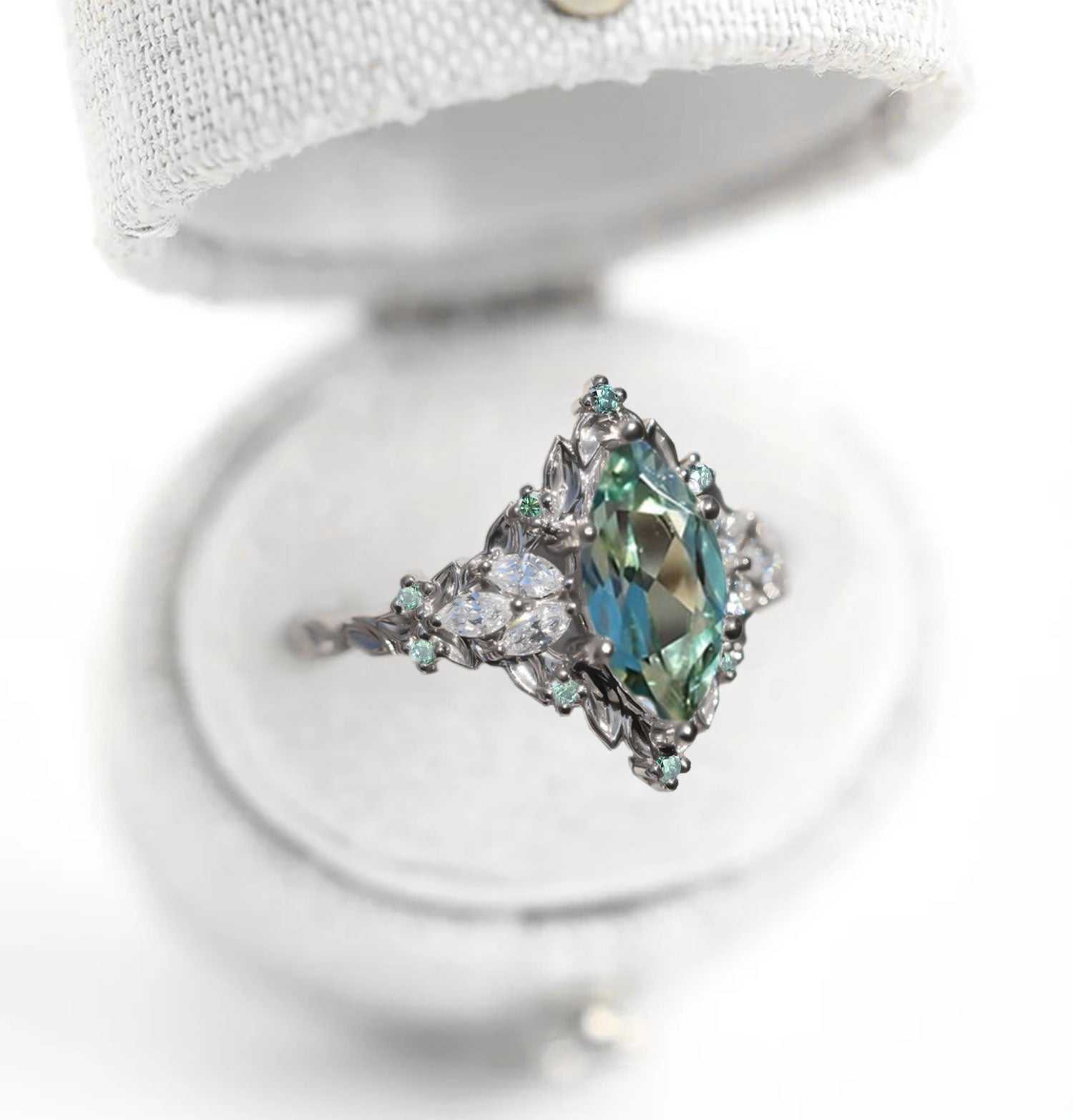 Wendelith solitaire engagement ring with marquise sapphire and moissanite side stones in elegant delicate band