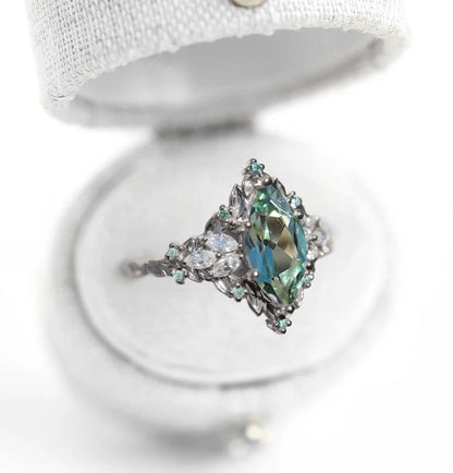 Wendelith solitaire engagement ring with marquise sapphire and moissanite side stones in elegant delicate band