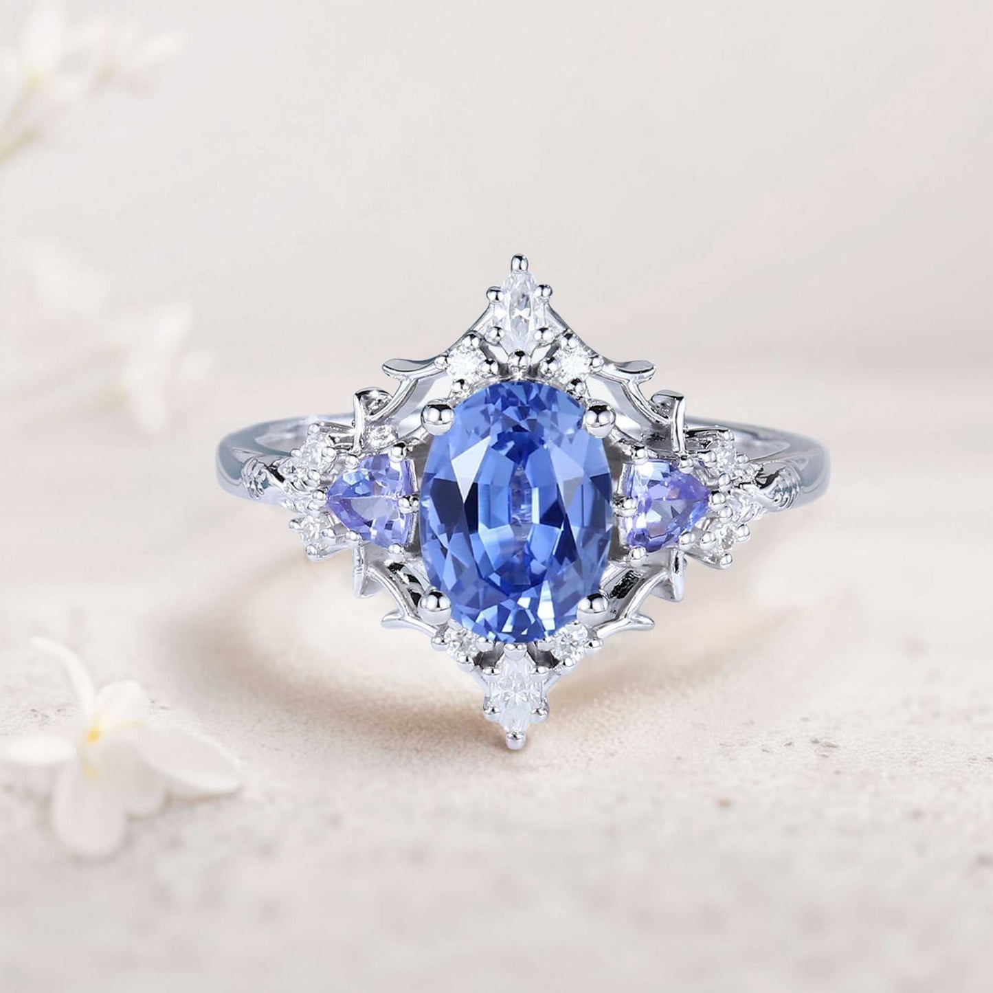 Corsaviel three-stone engagement ring with oval sapphire and side diamonds on silver band