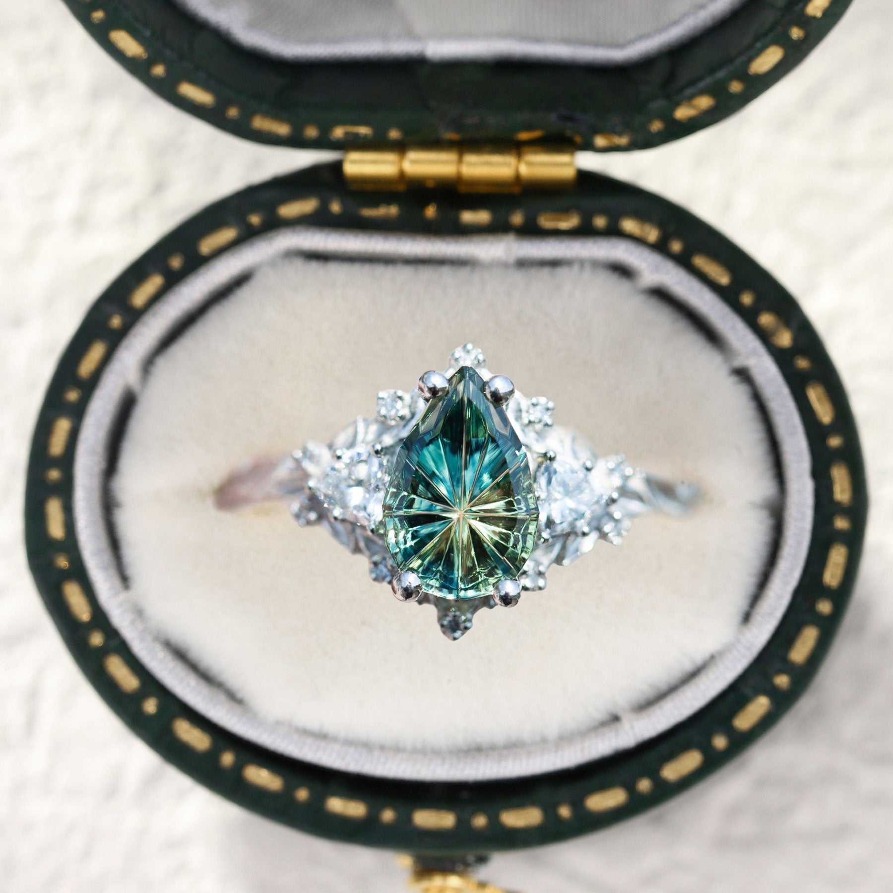Garaniel engagement ring with pear-shaped sapphire and moissanite stones in vintage box