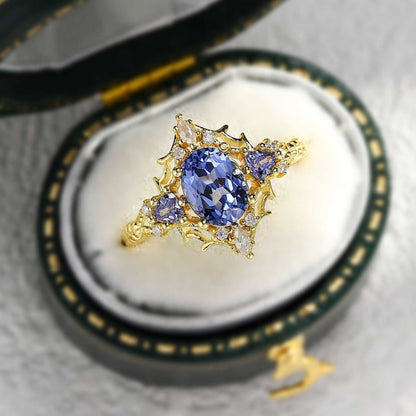 Corsaviel three-stone engagement ring with oval sapphire center and gold setting