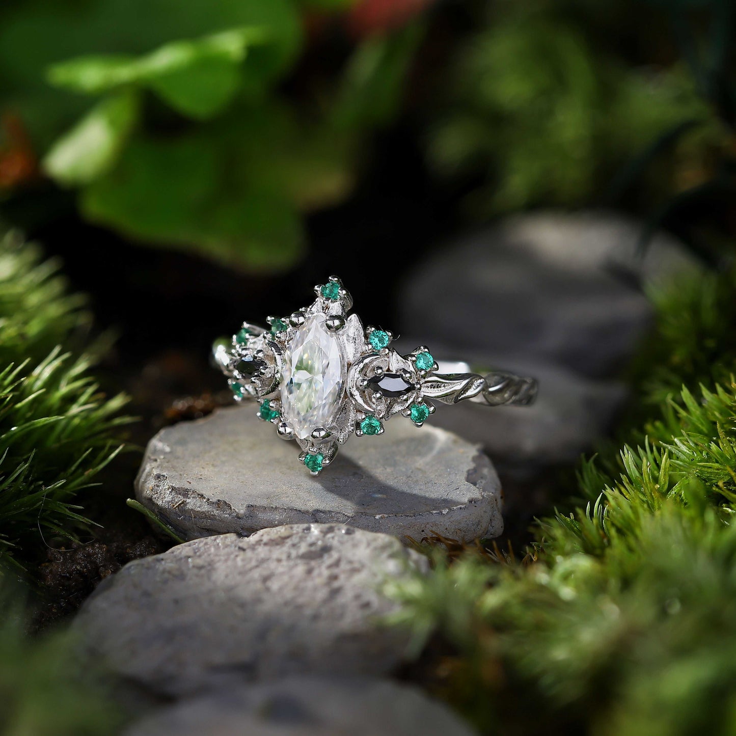 Wynriel engagement ring with marquise moissanite center and green gemstone accents on silver band