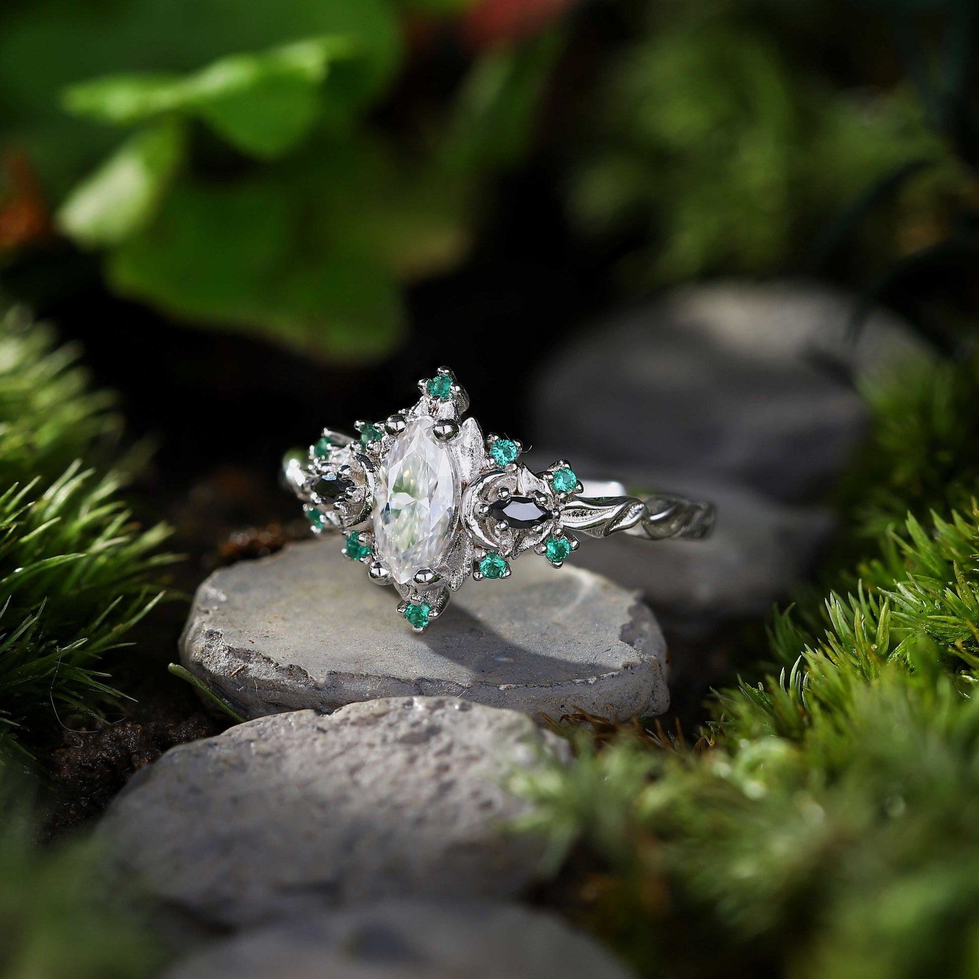 Wynriel engagement ring with marquise moissanite center and green gemstone accents on silver band