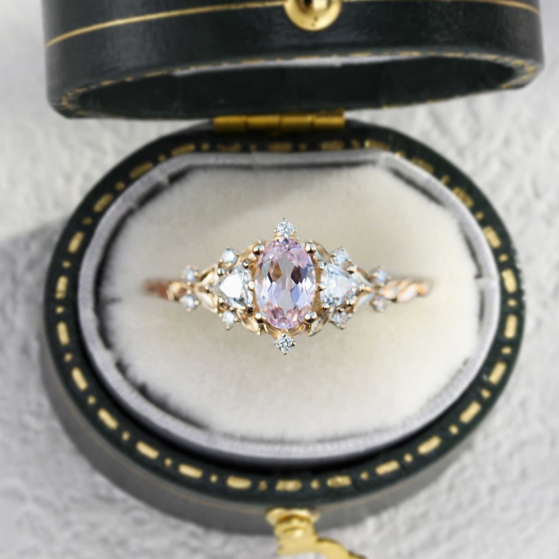 Uthriel three-stone engagement ring with oval sapphire center and moissanite side stones in vintage box