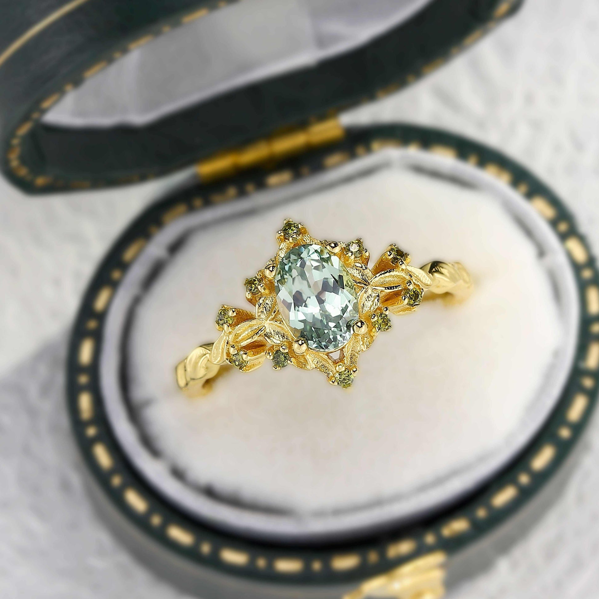 Xevoria solitaire engagement ring with oval sandstone center stone and gold twisted band in jewelry box