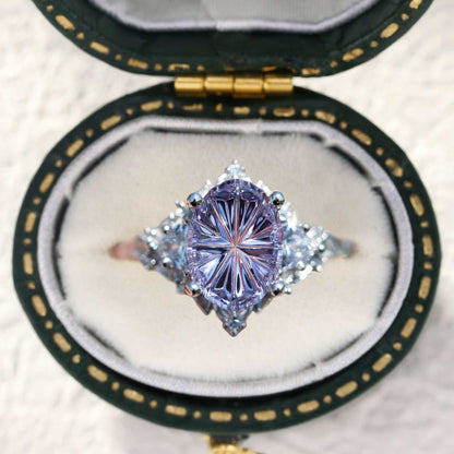 Ureswen three-stone engagement ring with oval sapphire and moissanite side stones in a velvet box
