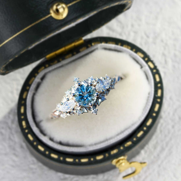 Nelawen three-stone engagement ring with 6mm aquamarine center and moissanite side stones in black velvet box
