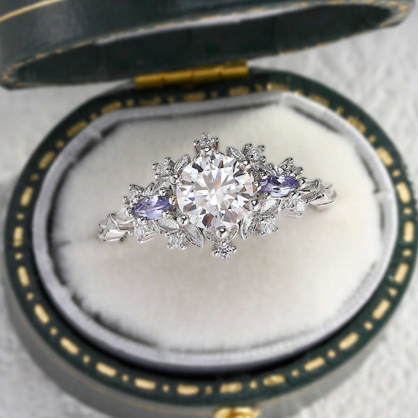 Rilaswen ring with round moissanite center stone and two smaller accented stones in elegant setting