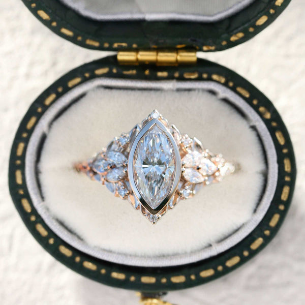 Uthawen solitaire engagement ring with marquise-shaped moissanite and delicate band in a velvet box