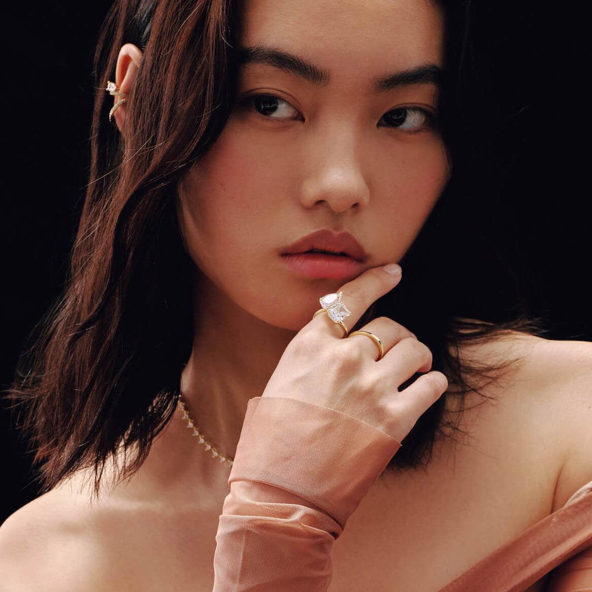 Lalinor engagement ring with 6.5-carat pear-shaped moissanite stones on model's hand in a Toi Et Moi design