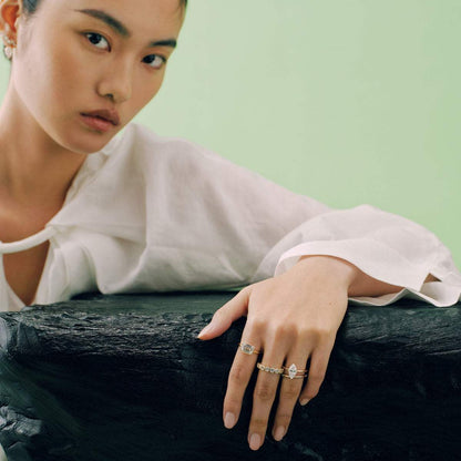 Roen Ring Damariel with 2.3 carat east-west emerald moissanite solitaire on split shank design worn on model's hand