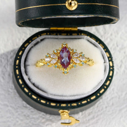 Lysaniel solitaire engagement ring with marquise lab Alexandrite and moissanite side stones in gold setting