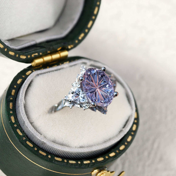 Ureswen three-stone engagement ring with oval sapphire and moissanite side stones in green velvet box