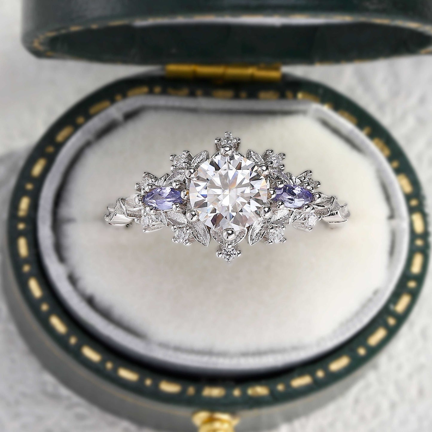 Rilaswen ring with round moissanite center and two smaller stones in elegant setting