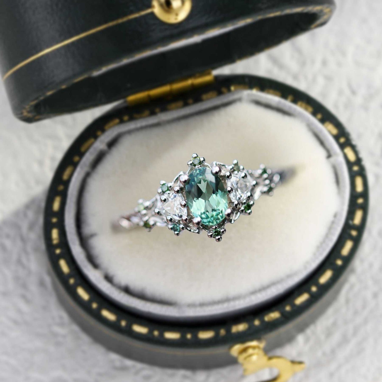 Dulawen three-stone engagement ring with oval sapphire and trillion moissanite side stones in elegant vintage box