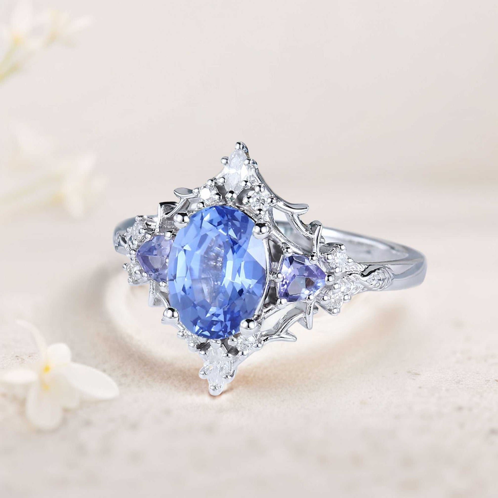 Corsaviel three-stone engagement ring with oval sapphire center and sparkling side stones