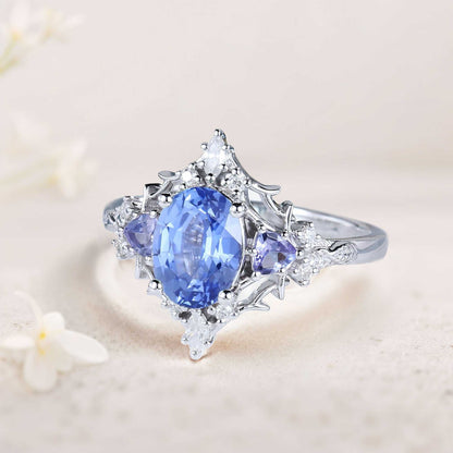 Corsaviel three-stone engagement ring with oval sapphire center and sparkling side stones