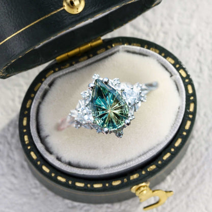 Garaniel solitaire engagement ring with pear-shaped sapphire and moissanite accents in a velvet box