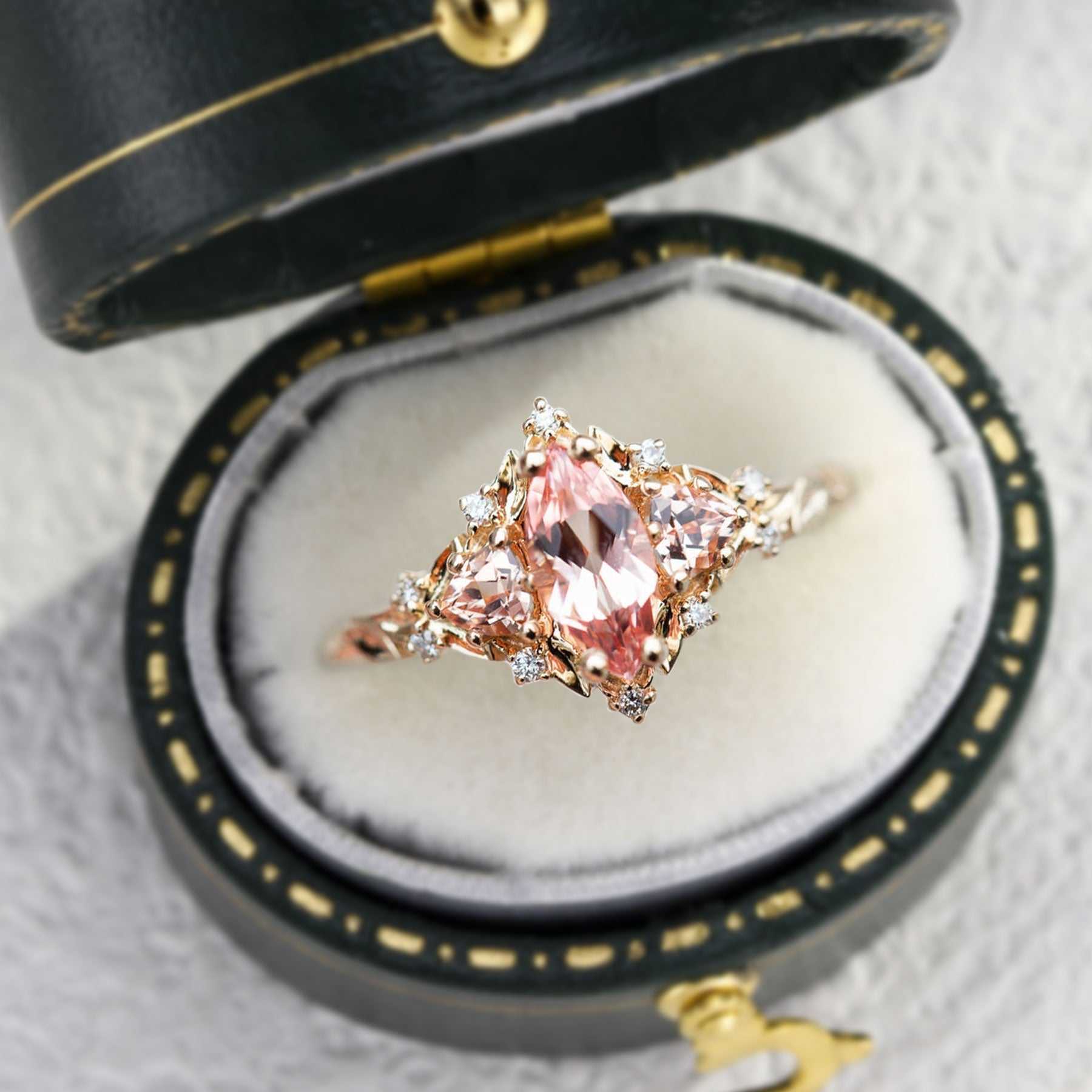 Nestariel engagement ring with marquise sapphire and diamond accents in elegant box
