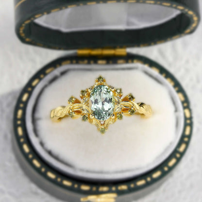Xevoria solitaire engagement ring with oval sandstone center and delicate round sandstone accents in gold setting