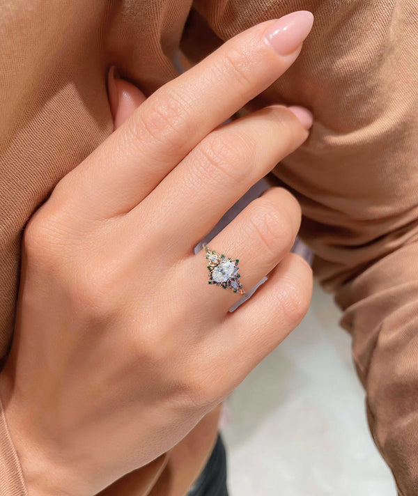 Belinor ring with pear-shaped moissanite center stone and delicate side stones on hand
