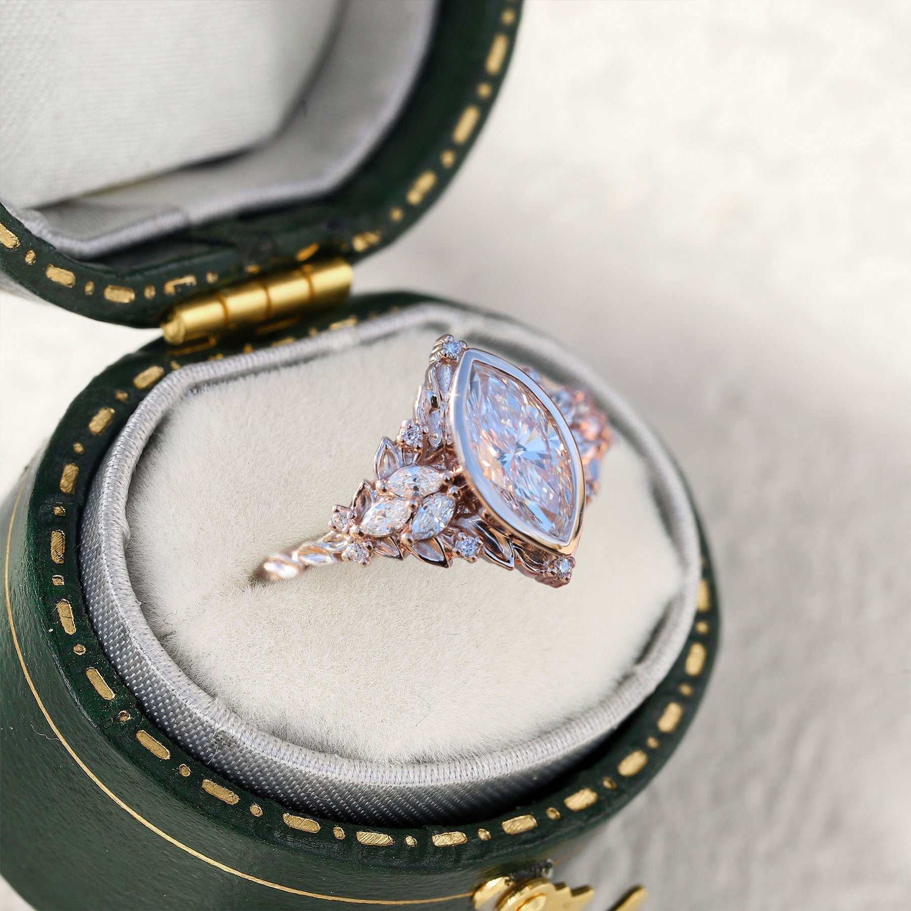 Uthawen solitaire engagement ring with marquise-shaped moissanite in green velvet box