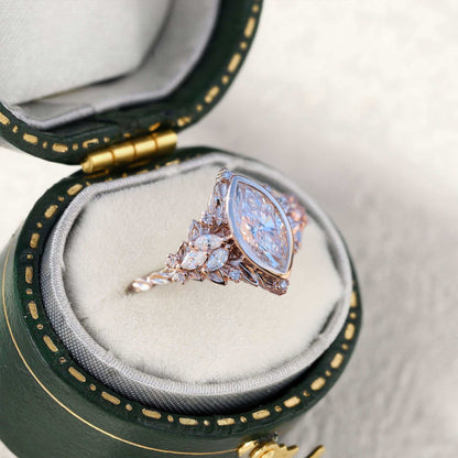 Uthawen solitaire engagement ring with marquise-shaped moissanite in green velvet box