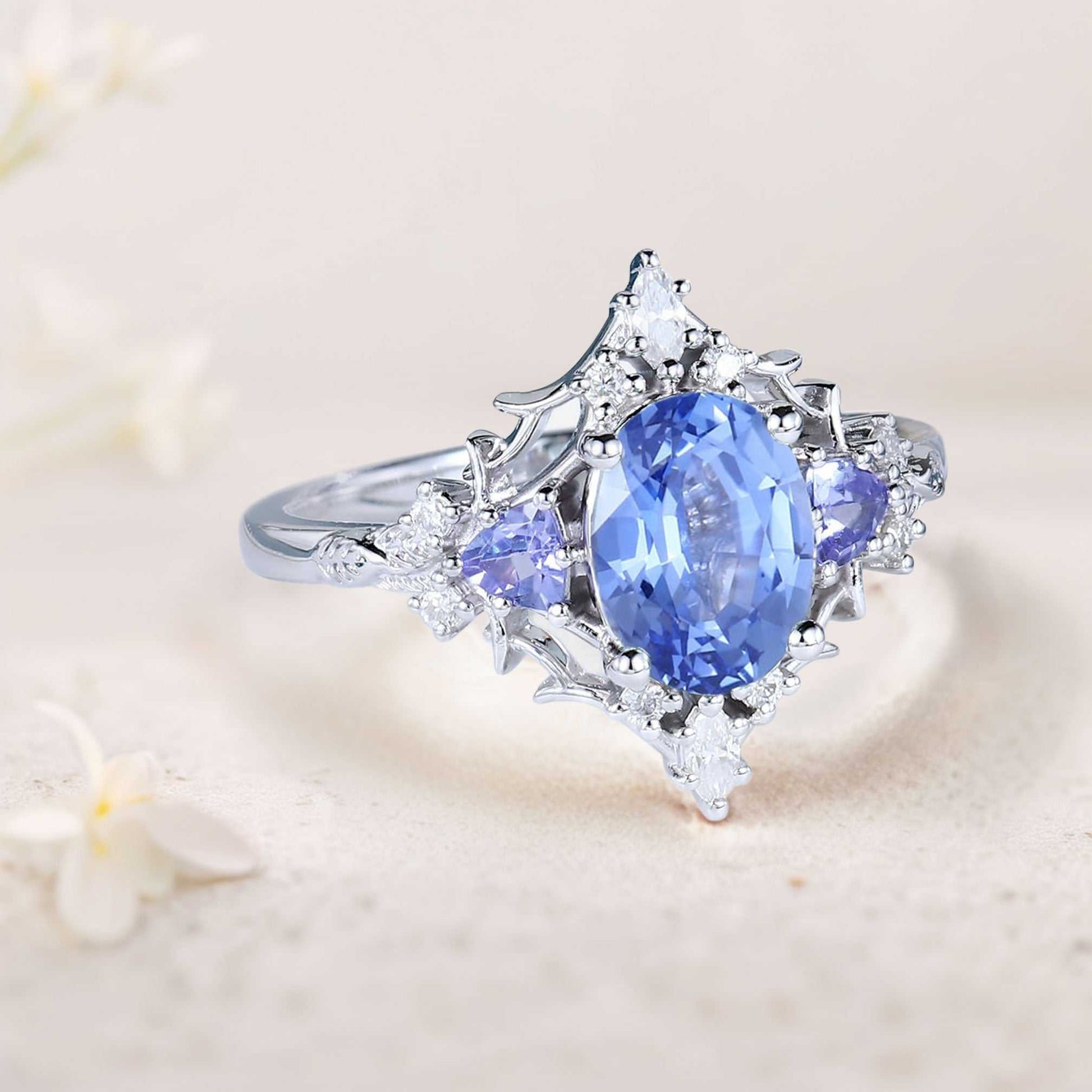 Corsaviel three-stone engagement ring with oval sapphire and diamond accents