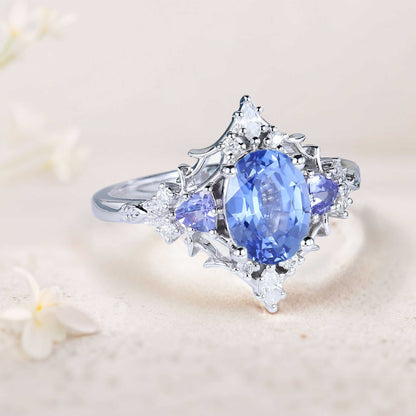 Corsaviel three-stone engagement ring with oval sapphire and diamond accents
