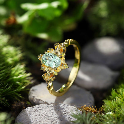 Xevoria solitaire engagement ring with oval sandstone center stone and delicate round sandstone accents in gold setting