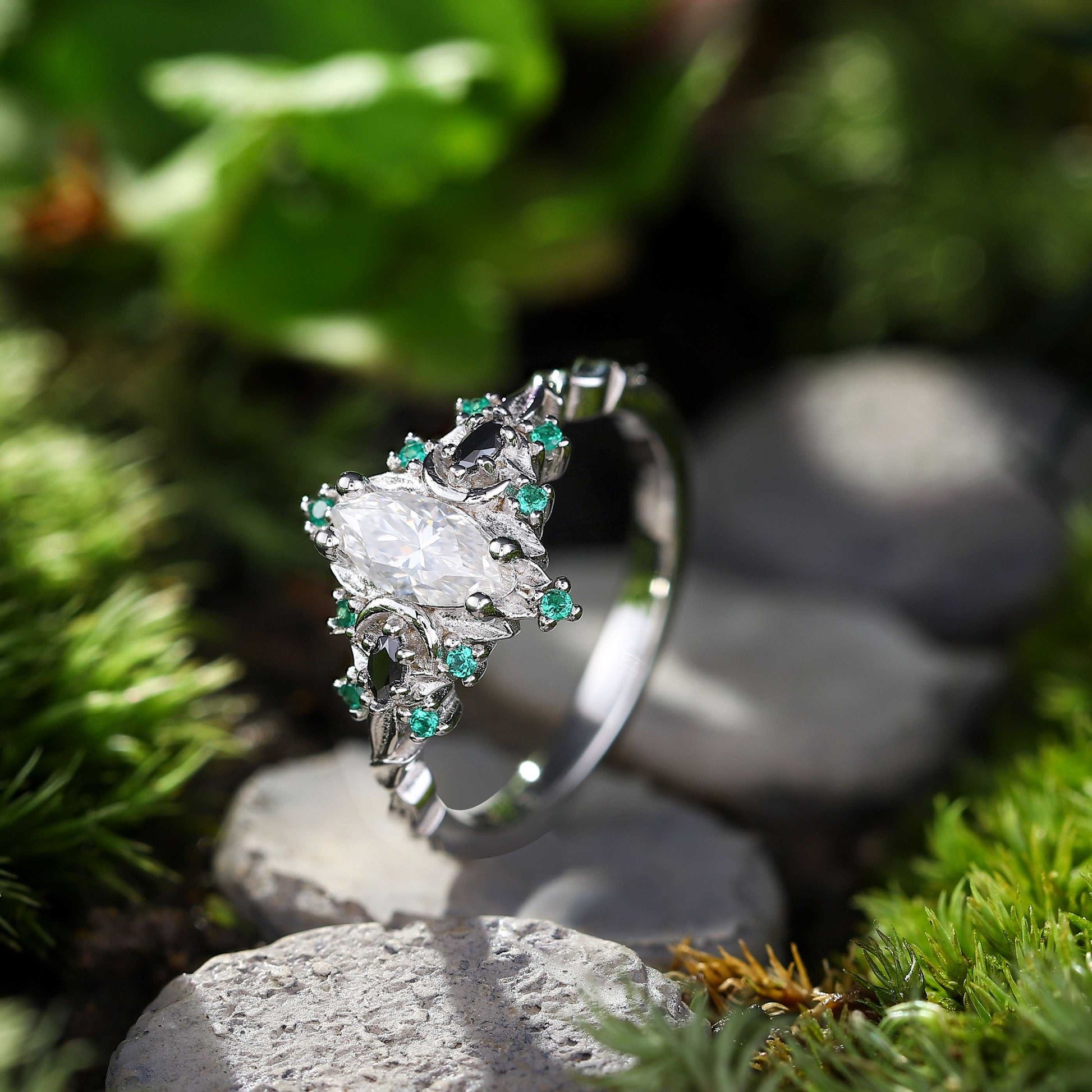 Wynriel three-stone engagement ring with marquise moissanite center and green gemstone accents on silver band