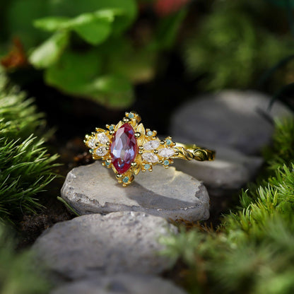 Lysaniel solitaire engagement ring with marquise lab Alexandrite and moissanite side stones on gold band
