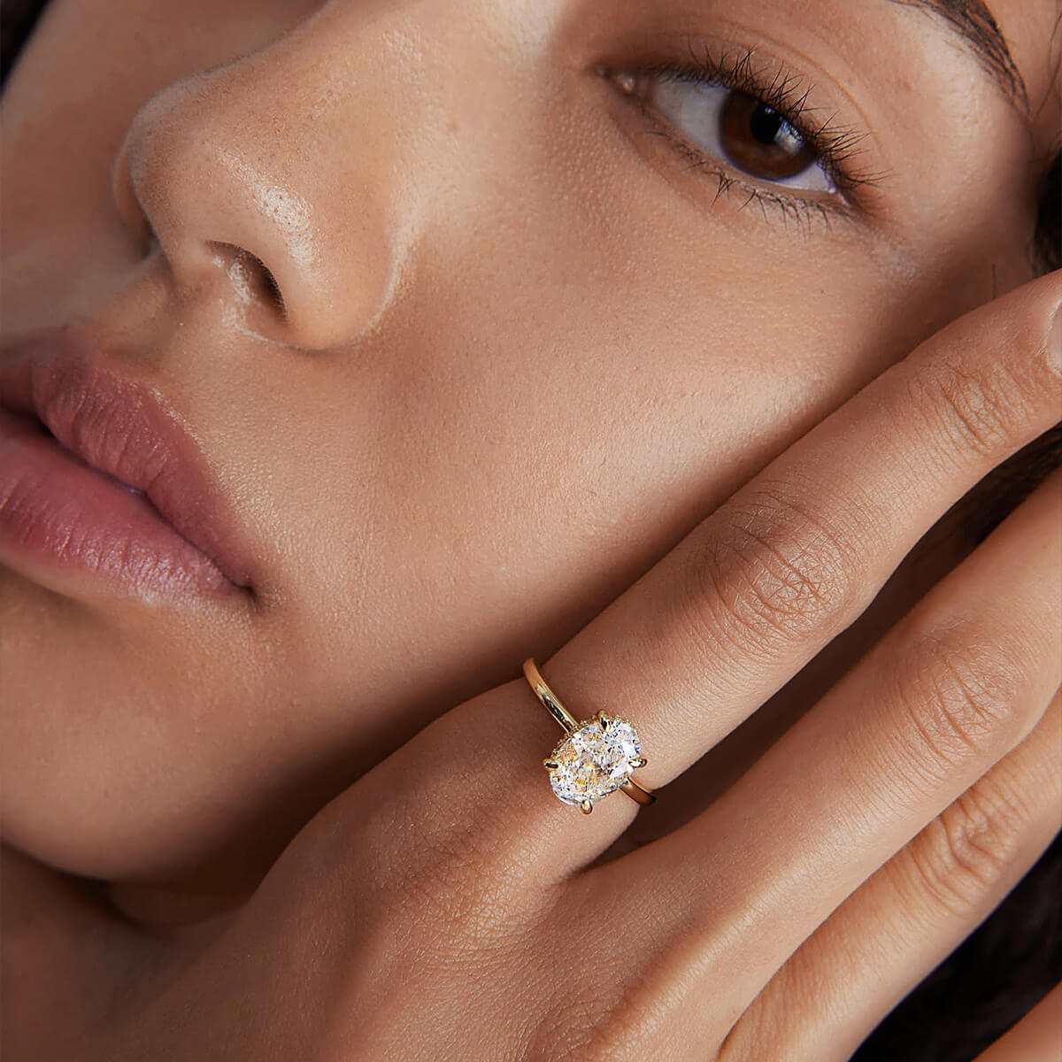 Nolindra solitaire engagement ring with oval Moissanite and pavé hidden halo on hand