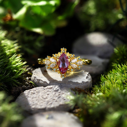 Lysaniel solitaire engagement ring with 8x4mm marquise alexandrite and 0.7ct marquise and round moissanite side stones on gold band