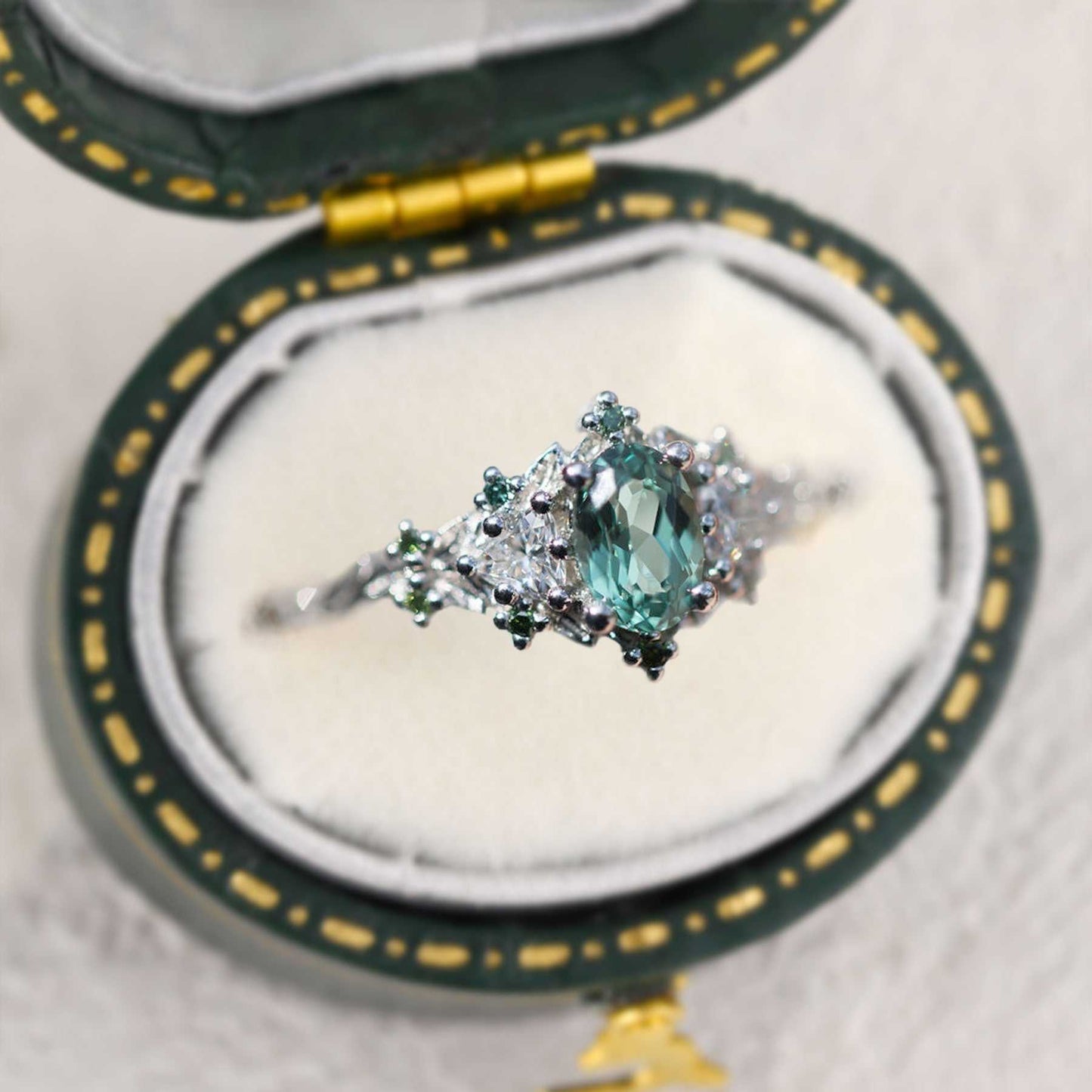 Dulawen three-stone engagement ring with oval sapphire and moissanite side stones in a vintage box