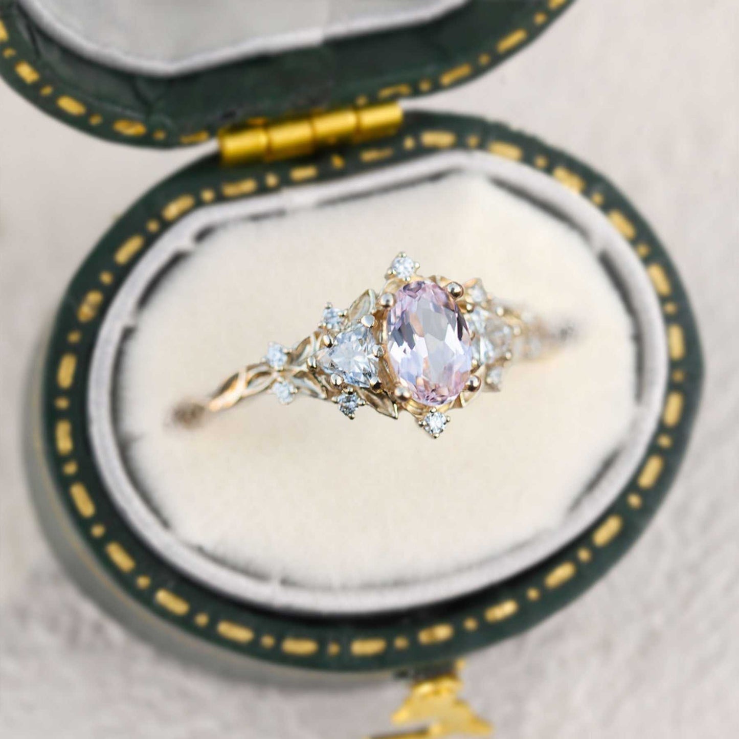 Uthriel three-stone engagement ring with oval sapphire center and moissanite side stones in vintage box