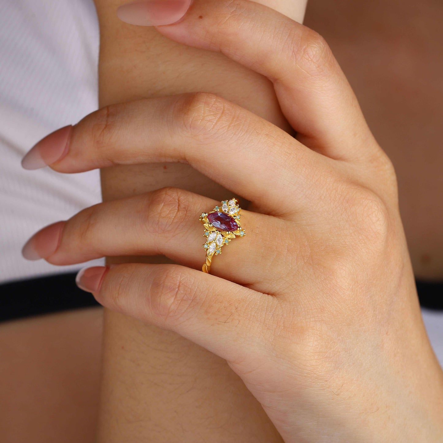 Lysaniel solitaire engagement ring with marquise-shaped lab Alexandrite and moissanite side stones on hand