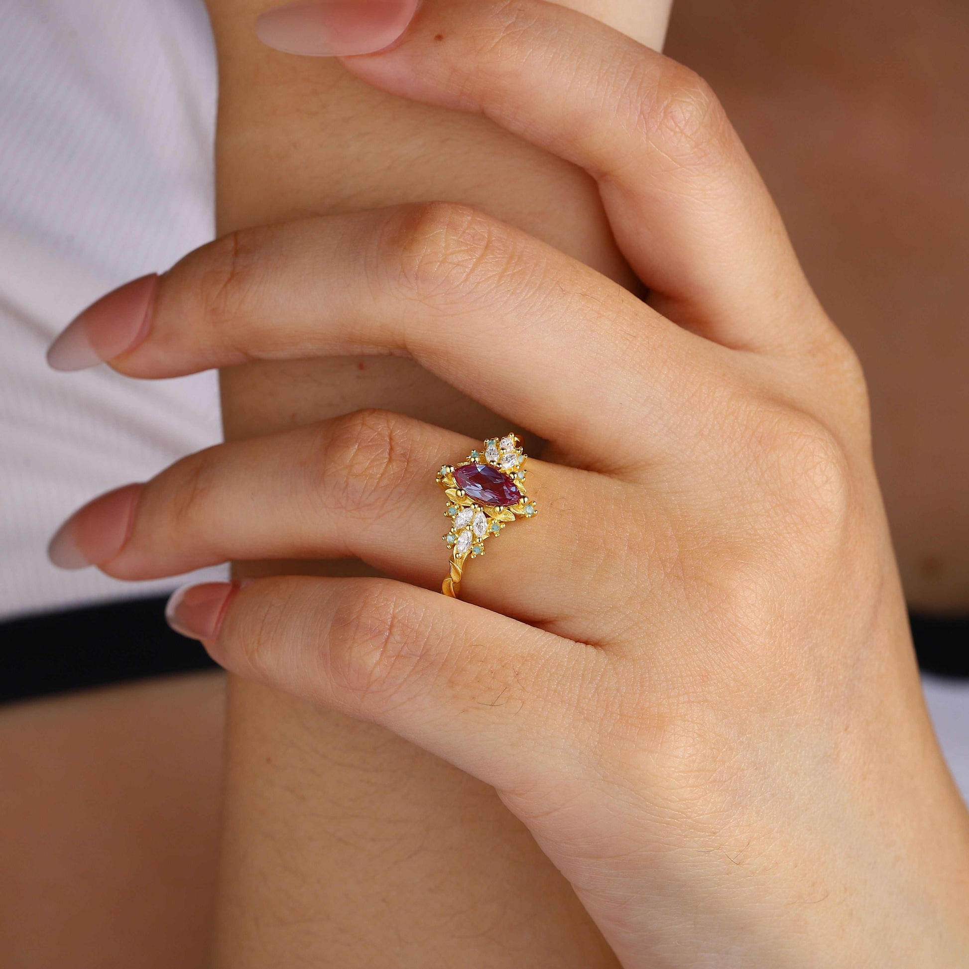Lysaniel solitaire engagement ring with marquise-shaped lab Alexandrite and moissanite side stones on hand
