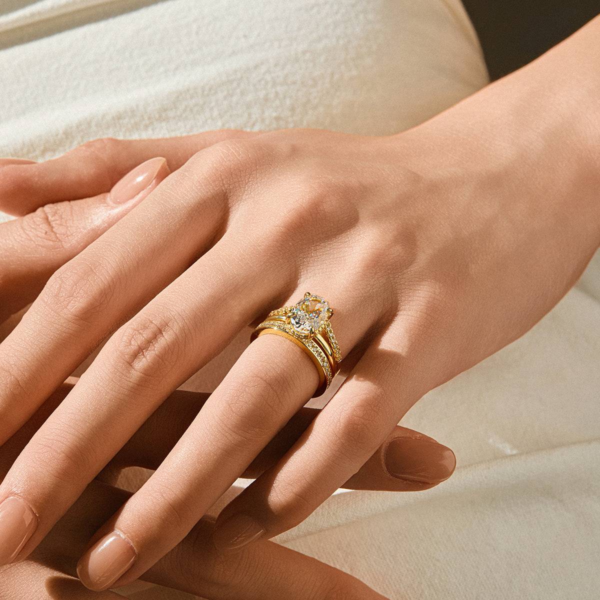 Nolindra solitaire engagement ring with oval Moissanite and pavé hidden halo on hand