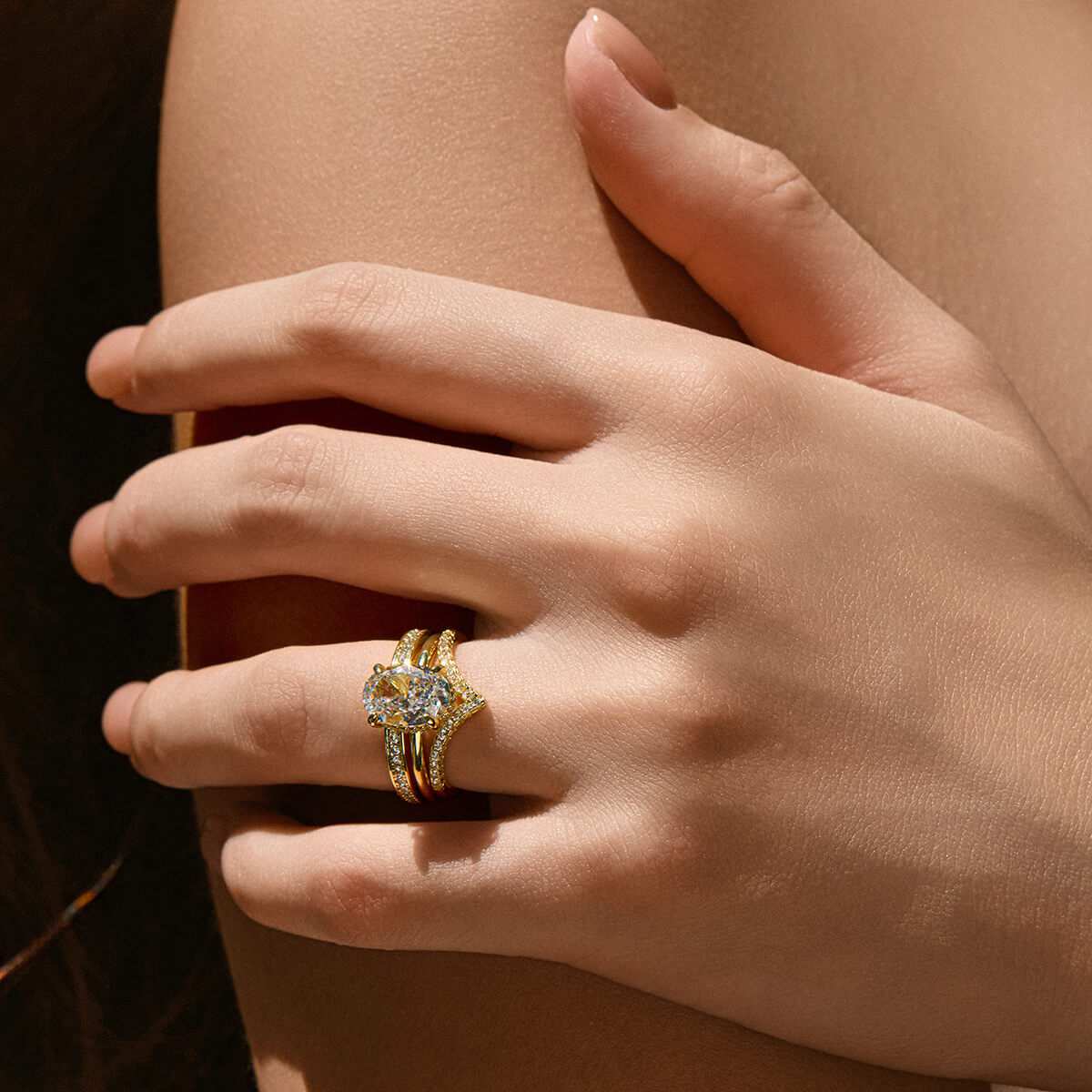 Nolindra solitaire engagement ring with oval Moissanite and pavé hidden halo on hand